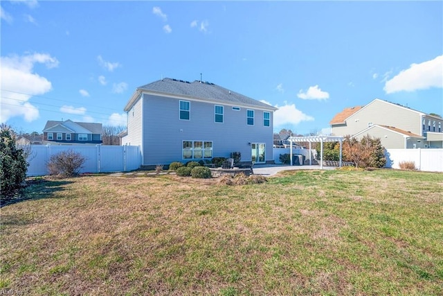 back of house with a fenced backyard, a lawn, a patio, and a pergola