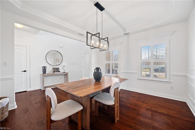 dining space featuring dark wood-style floors, crown molding, an inviting chandelier, and baseboards