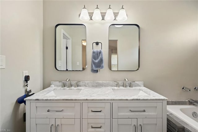 bathroom with double vanity, tiled tub, and a sink