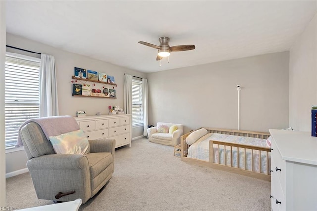 carpeted bedroom featuring ceiling fan and baseboards