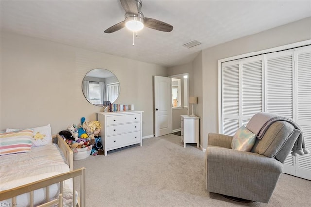 bedroom featuring ceiling fan, a closet, baseboards, and carpet flooring