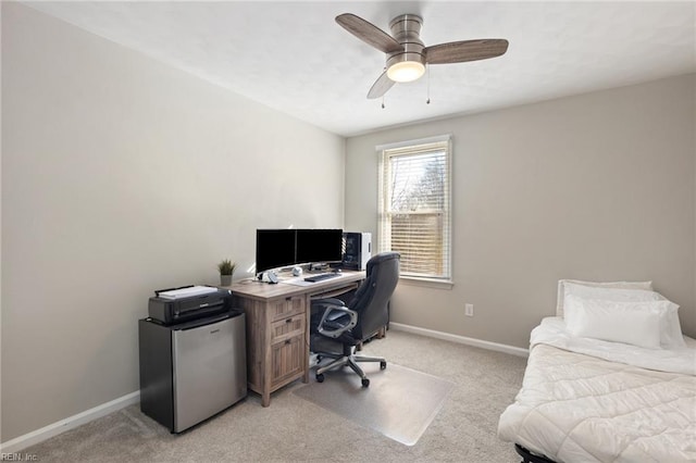 office space featuring ceiling fan, baseboards, and light colored carpet