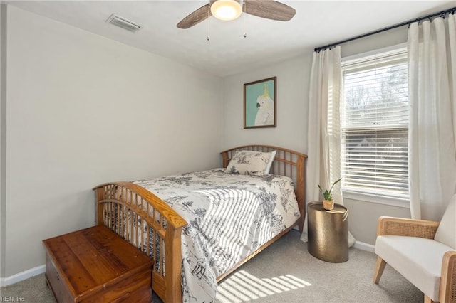 carpeted bedroom with baseboards, visible vents, and a ceiling fan