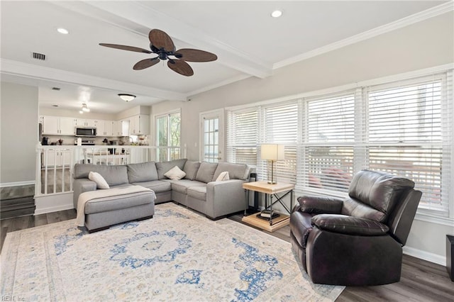 living area with crown molding, baseboards, dark wood-type flooring, and beamed ceiling