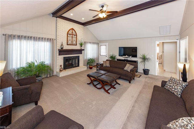 living area featuring vaulted ceiling with beams, visible vents, a ceiling fan, a brick fireplace, and carpet flooring