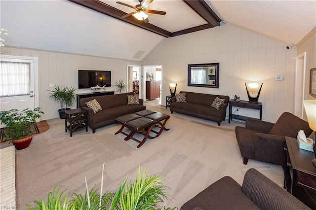 living room with vaulted ceiling with beams, carpet flooring, and a ceiling fan