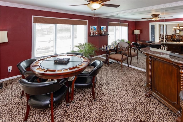 dining room featuring baseboards, ornamental molding, and a ceiling fan