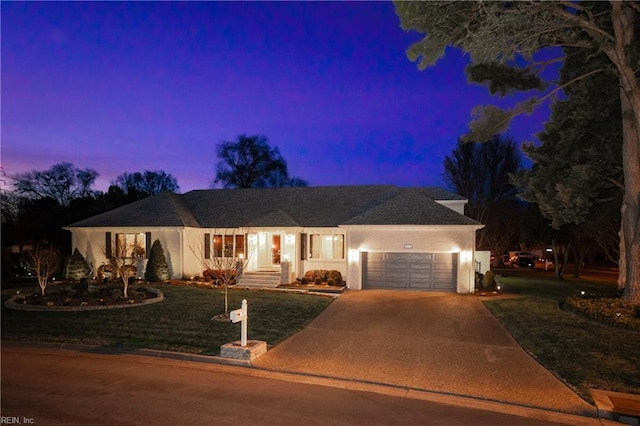 ranch-style home with a front yard, driveway, an attached garage, and stucco siding