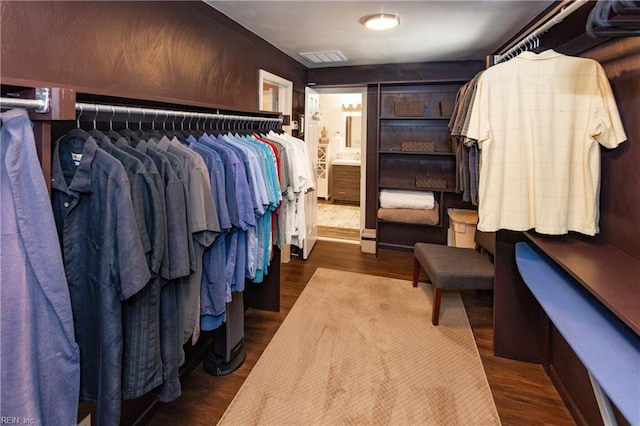 spacious closet featuring wood finished floors and visible vents