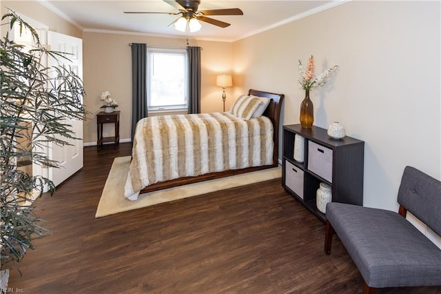 bedroom with baseboards, ornamental molding, ceiling fan, and wood finished floors