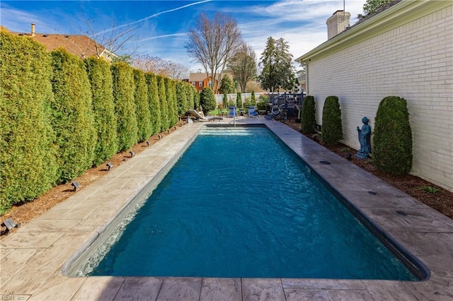 view of pool featuring a fenced in pool and a fenced backyard