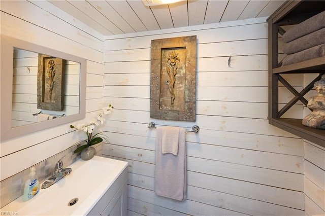 bathroom with wood ceiling and vanity