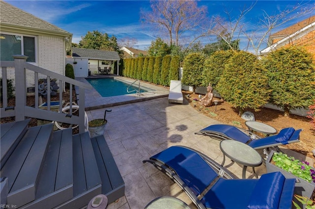 view of swimming pool featuring a fenced in pool, a patio area, a fenced backyard, an outdoor structure, and a storage structure