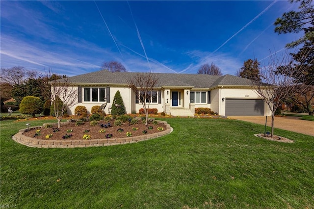 single story home with a front yard, driveway, and an attached garage