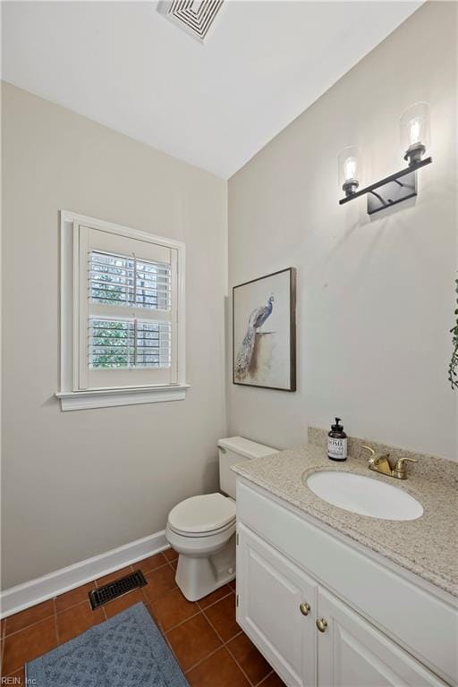 bathroom with toilet, baseboards, visible vents, and tile patterned flooring