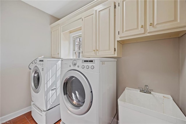 washroom with tile patterned floors, a sink, cabinet space, and washer and dryer