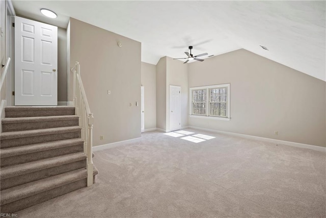 unfurnished living room featuring light carpet, stairs, baseboards, and vaulted ceiling