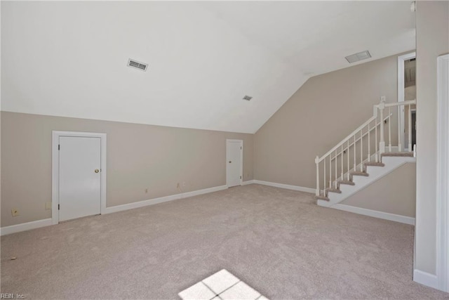 bonus room with light colored carpet, visible vents, vaulted ceiling, and baseboards