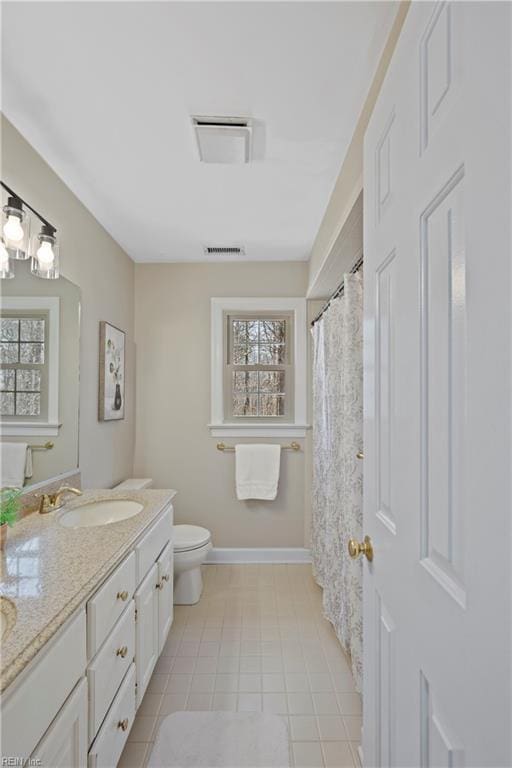 full bathroom with toilet, a sink, visible vents, baseboards, and double vanity