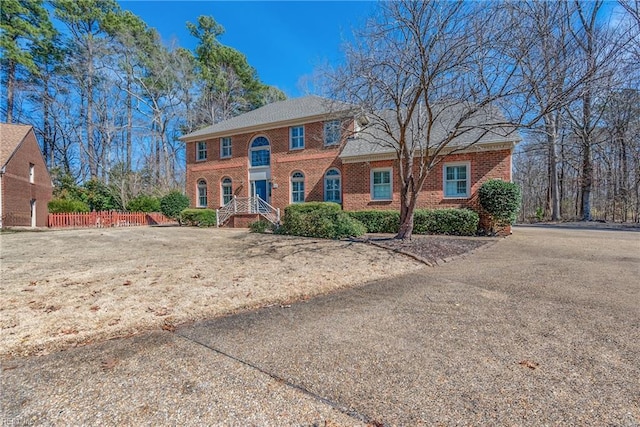 view of front of property with fence and brick siding