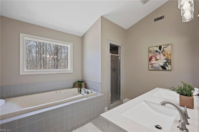 full bath featuring visible vents, vaulted ceiling, a shower stall, and a bath