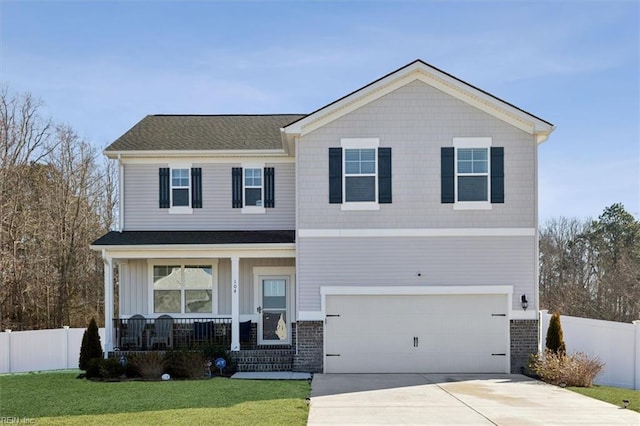 view of front of home with driveway, a porch, fence, a front lawn, and brick siding