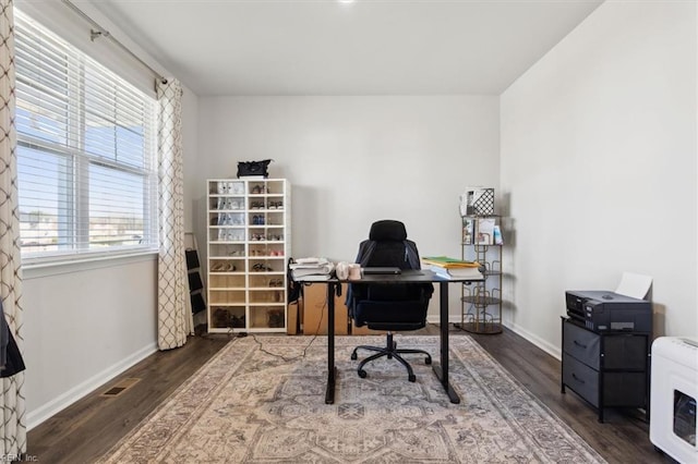 office space with wood finished floors, visible vents, and baseboards