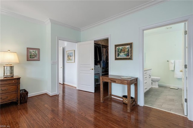 bedroom with baseboards, ensuite bath, ornamental molding, wood finished floors, and a closet