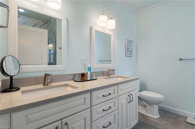 bathroom featuring ornamental molding, a sink, toilet, and double vanity