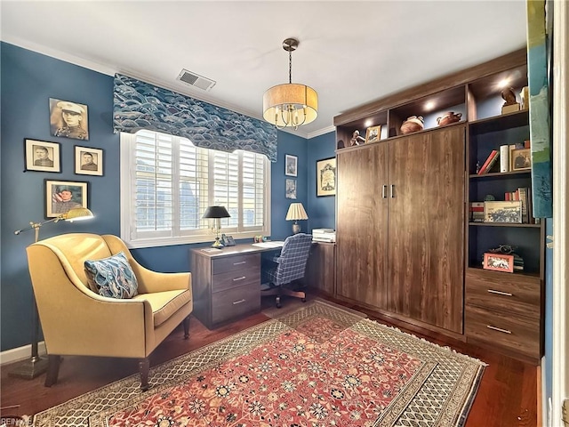 office area with baseboards, visible vents, dark wood-type flooring, crown molding, and a chandelier