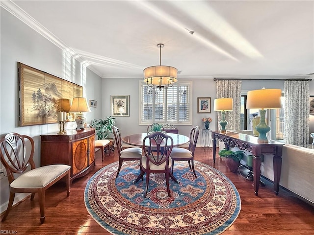 dining room featuring a notable chandelier, wood finished floors, and crown molding