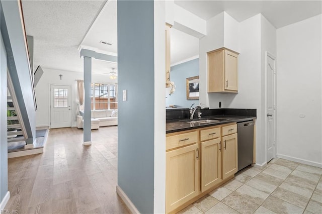 kitchen with decorative columns, a ceiling fan, dishwasher, dark countertops, and light brown cabinetry