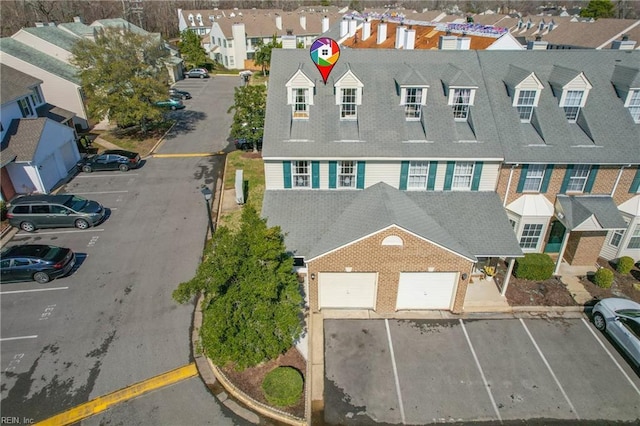 birds eye view of property with a residential view