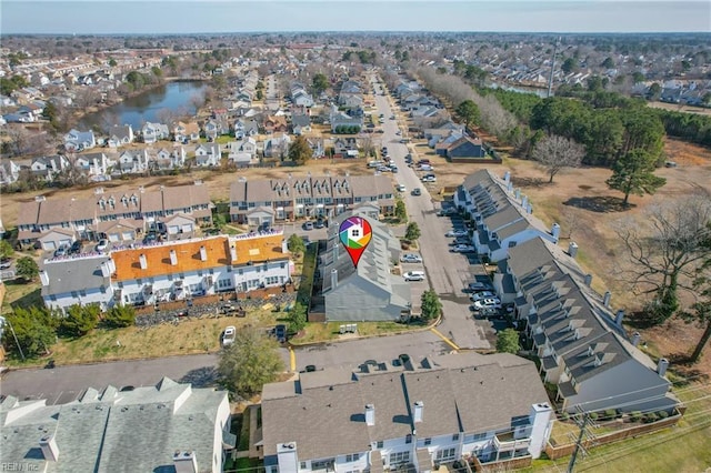 drone / aerial view with a water view and a residential view