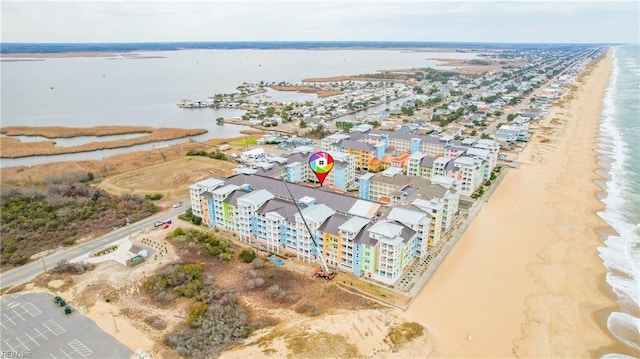 drone / aerial view featuring a view of the beach and a water view