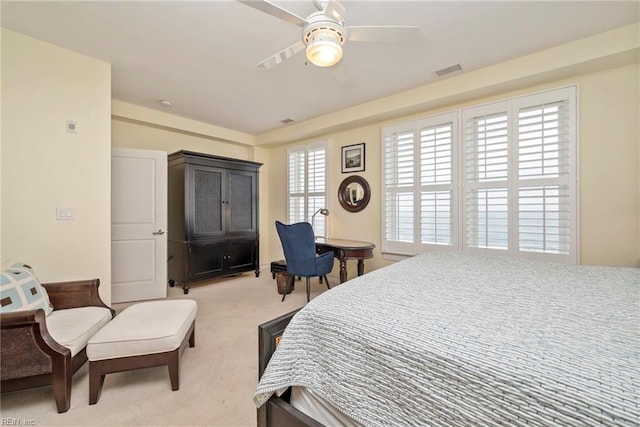 bedroom featuring light carpet, visible vents, and a ceiling fan