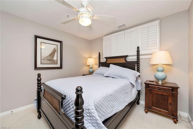 bedroom featuring light colored carpet, ceiling fan, visible vents, and baseboards