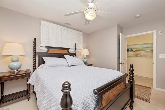 bedroom with baseboards, light colored carpet, visible vents, and a ceiling fan