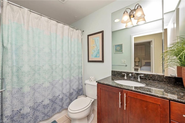 bathroom featuring toilet, a shower with curtain, vanity, and tile patterned floors