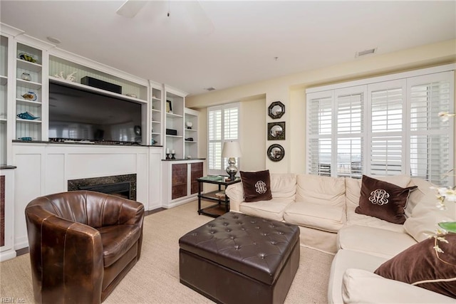 living area with a premium fireplace and visible vents