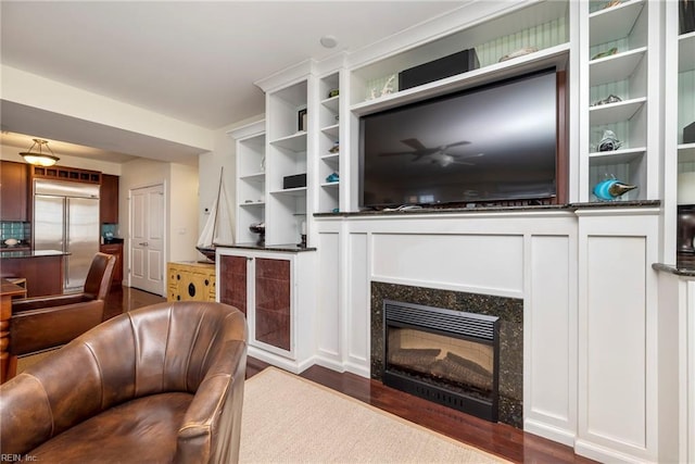 living room featuring dark wood-style flooring and a glass covered fireplace