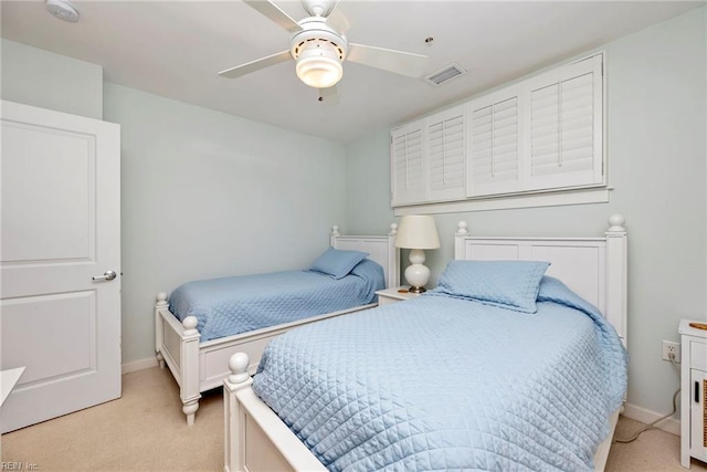 bedroom with light carpet, baseboards, and a ceiling fan