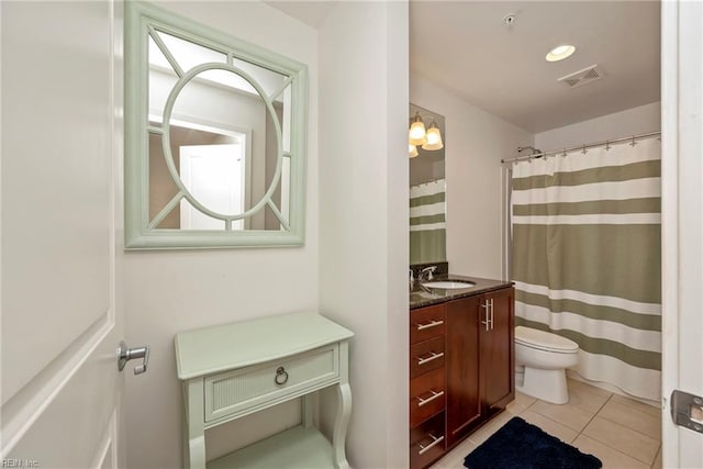 bathroom featuring visible vents, vanity, toilet, and tile patterned floors