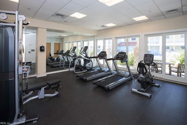 workout area featuring a paneled ceiling and visible vents