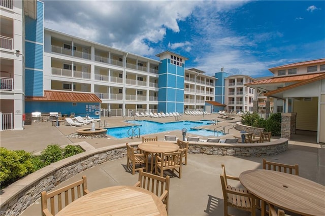 pool featuring outdoor dining area and a patio