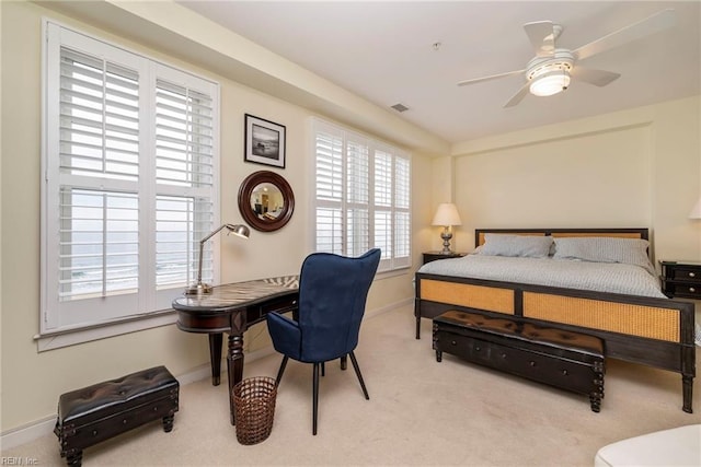 carpeted bedroom with visible vents and baseboards