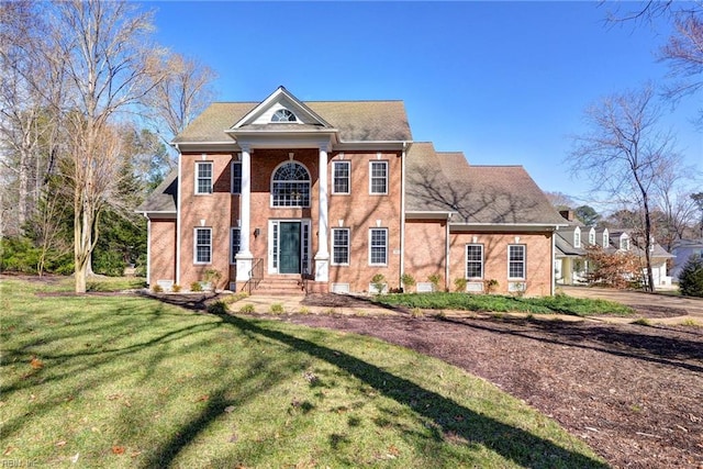 greek revival inspired property featuring a front lawn