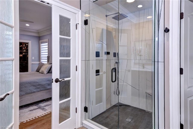 full bath featuring recessed lighting, french doors, ornamental molding, a shower stall, and ensuite bath