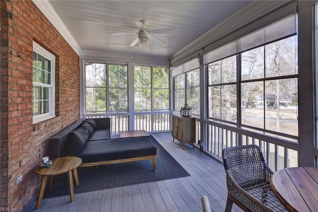 sunroom / solarium featuring a ceiling fan