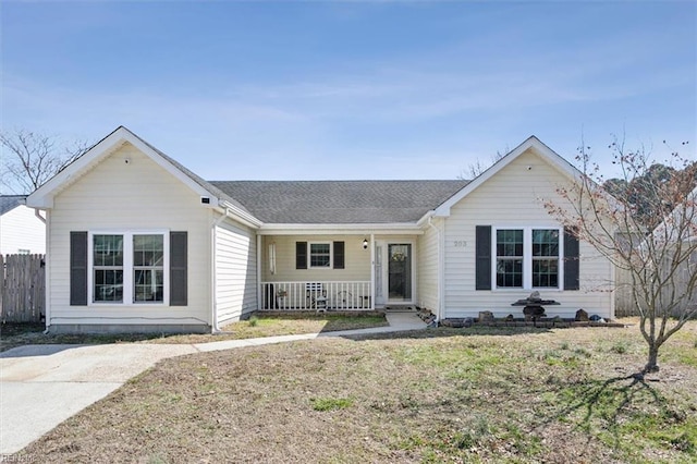 ranch-style house with a porch, a front lawn, a shingled roof, and fence